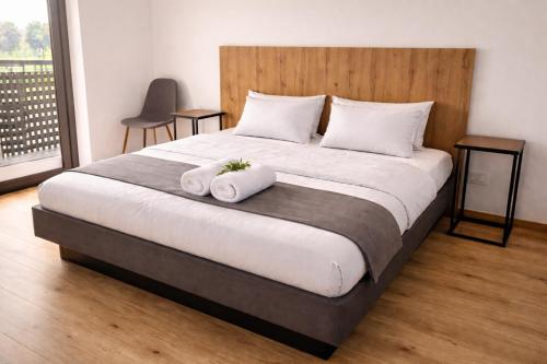 a bedroom with a large bed with two towels at Romantic Sunset Retread I 4 Min to A2 I E-Bikes I Near Ljubljana in Velika Loka