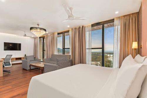 a bedroom with a white bed and a room with a view at Country Inn Rishikesh at Laxman Jhula in Rishīkesh