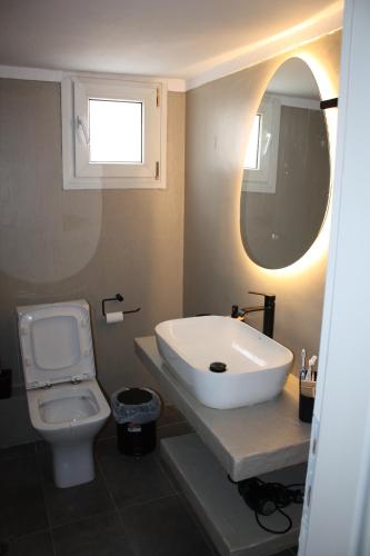 a bathroom with a sink and a toilet at Despina's apts in Kalamariá