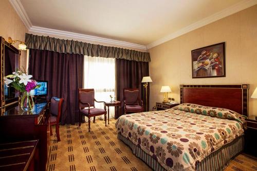 a hotel room with a bed and a television at El Mohandseen Cairo Hotel in Cairo