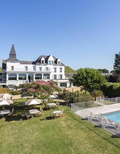 a large white building with a swimming pool and a resort at Hotel Restaurant Spa du Tumulus Carnac in Carnac