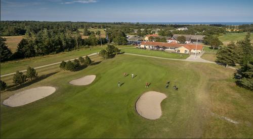 an overhead view of a golf course with people on the greens at DCU-Camping Ålbæk Strand in Ålbæk