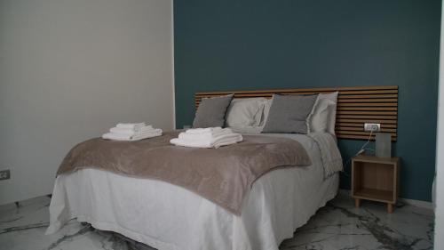 a bedroom with a large bed with towels on it at A Casa Mia 2.0 in Saronno