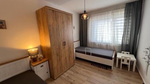a small bedroom with a small bed and a window at A2 - Viel Platz für alle in Wernigerode