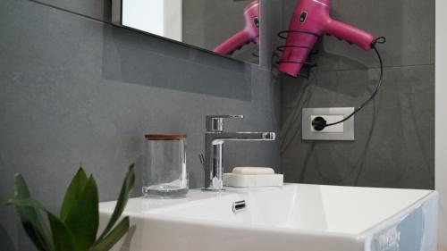 a bathroom with a sink and a pink faucet at A Casa Mia 2.0 in Saronno