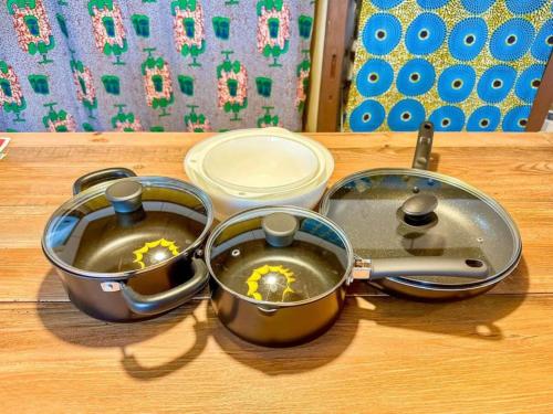 three pots and pans on a table with food at PolePole in Takamatsu