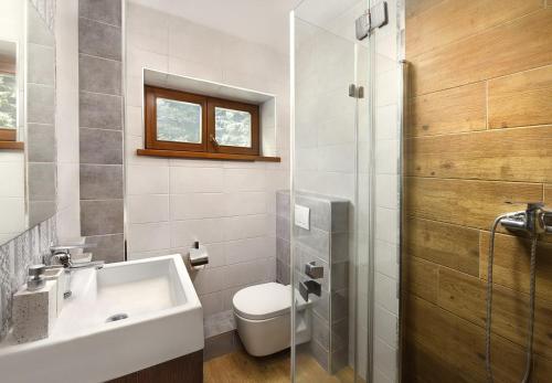 a bathroom with a toilet and a sink and a shower at Majláthova Chata Popradské Pleso in Vysoké Tatry