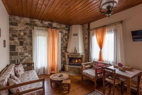 a living room with a couch and a fireplace at Studio Merses in Mikrón Khoríon