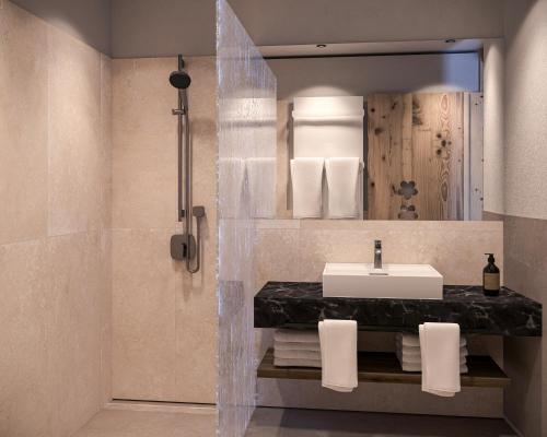 a bathroom with a sink and a mirror at Schiefergut Family Resort Flachau in Flachau