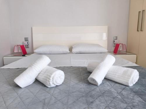 a bedroom with a bed with four white pillows at DENNIS PATRASSO - Modern apartment in Patras in Patra