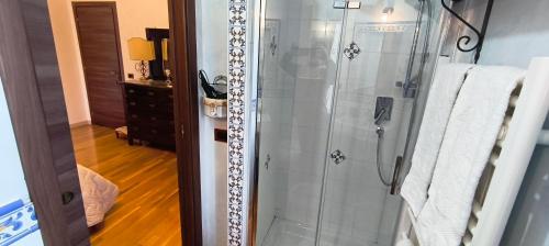 a bathroom with a shower with white towels at B&B Della Via Francigena in Agrigento