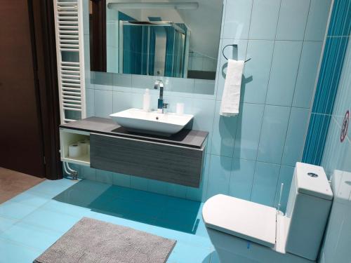 a blue bathroom with a sink and a toilet at DENNIS PATRASSO - Modern apartment in Patras in Patra
