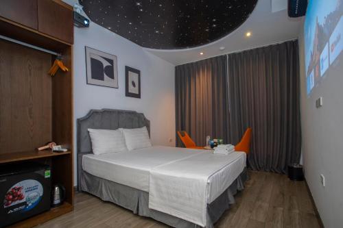 a bedroom with a bed in a room with stars on the ceiling at Boutique Hotel in Hanoi