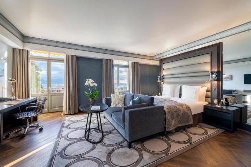 a hotel room with a bed and a desk at Royal Savoy Hotel & Spa in Lausanne