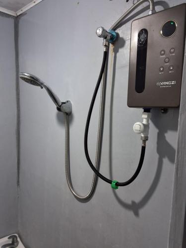 a phone hooked up to a wall in a room at D Bamboo House in Mabini