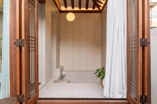 a bathroom with a shower with a bath tub at 안동 108한옥 in Andong