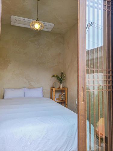 a bedroom with a bed and a sliding glass door at 안동 108한옥 in Andong