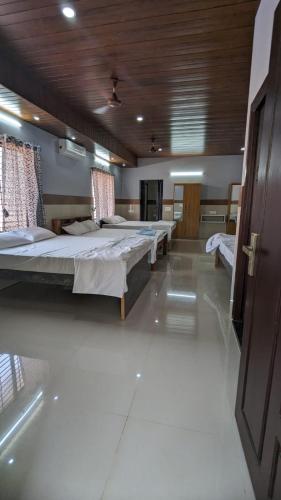 a large room with two beds in it at SJ Residency in Dharmastala