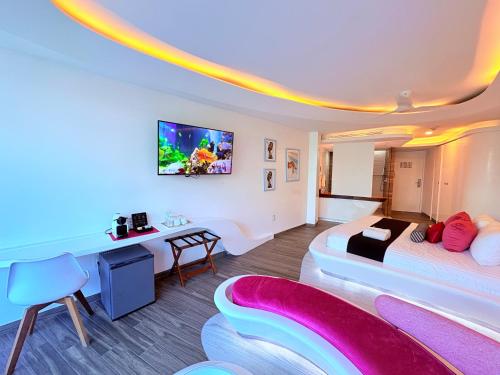 a hotel room with a large bed and a desk at Condohotel The Carmen Deluxe Oceanview King Suite in Playa del Carmen