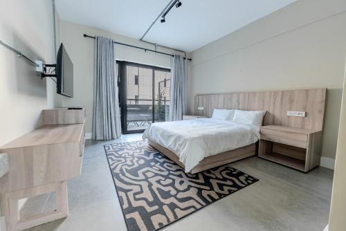 a bedroom with a bed and a rug at inn here in Johannesburg