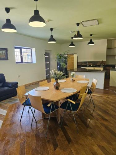 a dining table and chairs in a living room at Bethel Cottage in Oulton