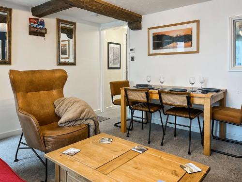 a living room with a table and chairs at North Lakes Town House in Penrith