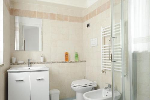 a bathroom with a toilet and a sink and a shower at Il Giardino di Valentina in Escolca