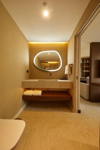 a bathroom with a sink and a mirror at Selimiye Sardunya Hotel & Restaurant in Marmaris