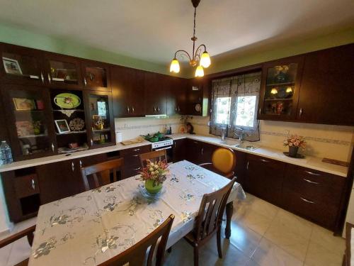 a kitchen with a table and some chairs and a table and a tableablish at MV House Goulediana Rethymno in Rethymno