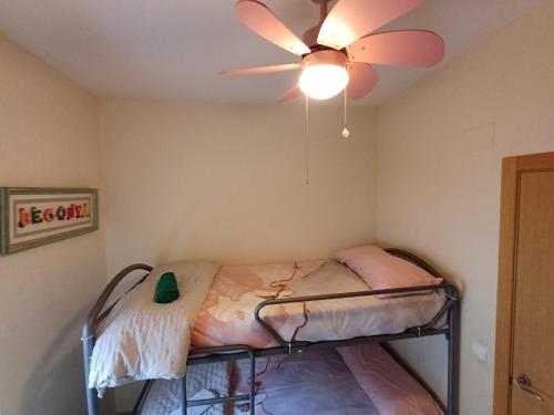 a bedroom with a bed with a ceiling fan at SELA HOME y Garaje, Algemesi Home in Algemesí
