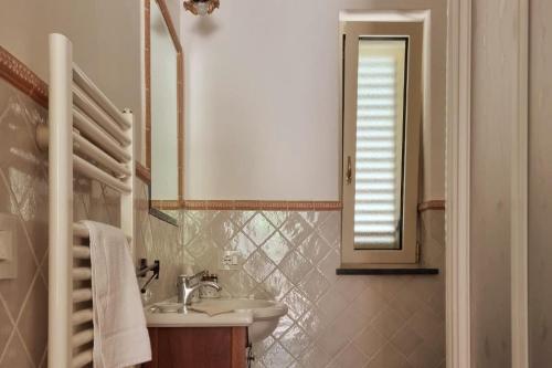 a bathroom with a sink and a mirror at Casa Vinaccia in Massa Lubrense