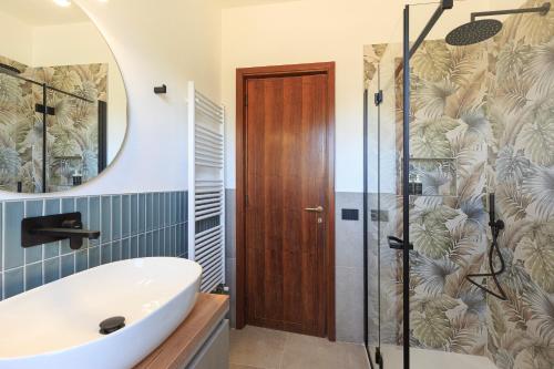 a bathroom with a sink and a shower at Baveno Beach - Charming Flat With Garden in Baveno