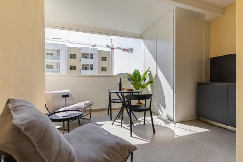 a living room with a couch and a table at Campo's Guest House Airport in Bari