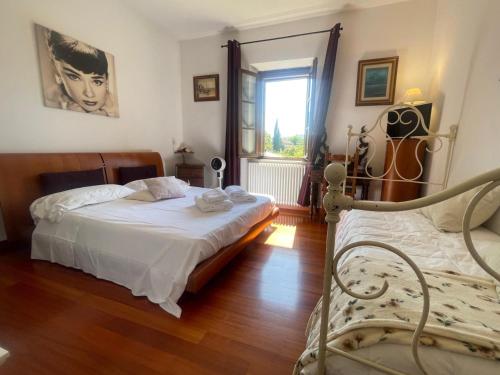 a bedroom with a bed and a window at Torre Della Chiocciola in Monteriggioni