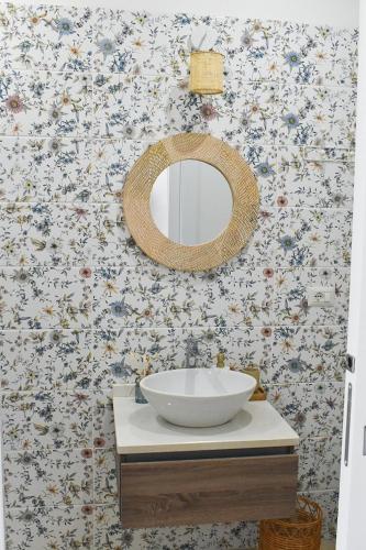 a bathroom with a white sink and a mirror at Casa Vacanze Maiorca & Minorca in Alghero