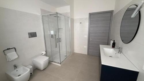 a bathroom with a shower and a toilet and a sink at Le Cupole in Marsala