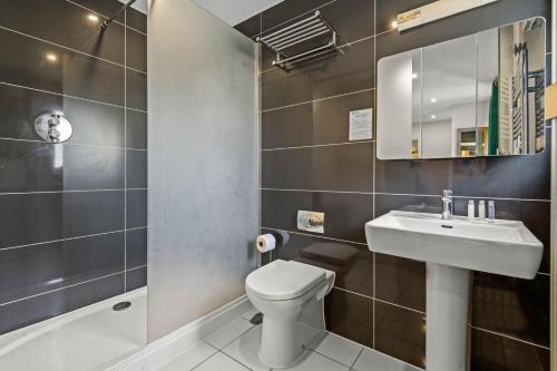 a bathroom with a white toilet and a sink at House 43 in Looe