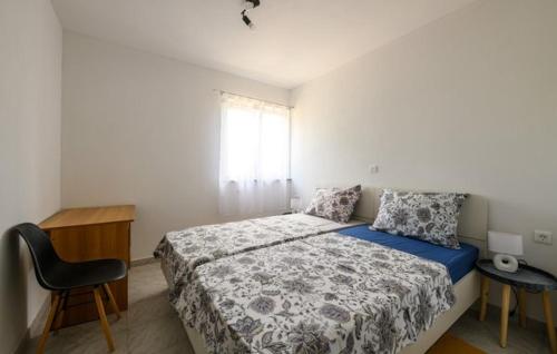 a bedroom with a bed and a desk and a window at Villa Paola Vinez in Labin
