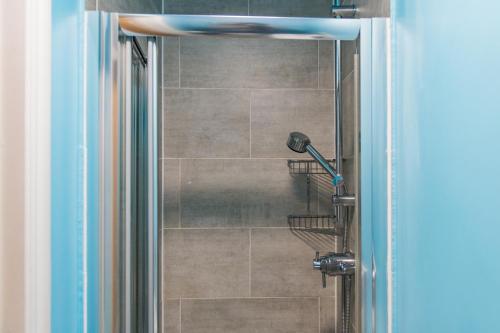 a shower in a bathroom with a glass door at Gerald's Place in Deal
