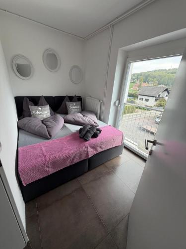 a bed in a room with a large window at Ferienwohnung Sophia in Bad Gleichenberg