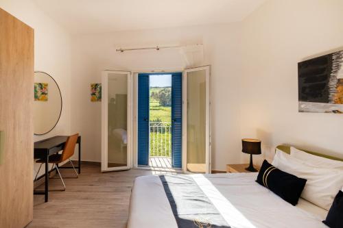 a bedroom with a bed and a table and a desk at Dar Sara Holiday Home in Victoria