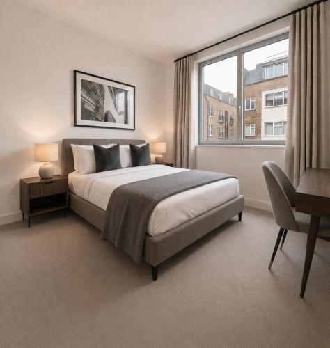 a bedroom with a large bed and a window at 2 Bed Liverpool Street Loft in London