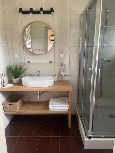 a bathroom with a sink and a shower at Domki Norda in Władysławowo