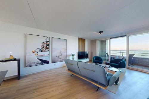 a living room with a couch and a table with chairs at Port Scaldis 05-012 in Breskens