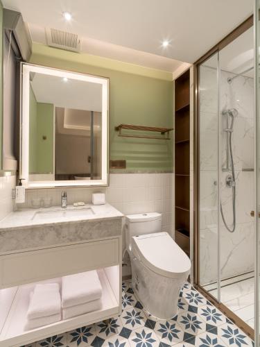 a bathroom with a toilet and a sink and a shower at 亞士都酒店 in Taipei
