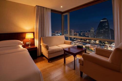 a hotel room with a bed and a view of the city at Pumpkin Hotel in Beijing
