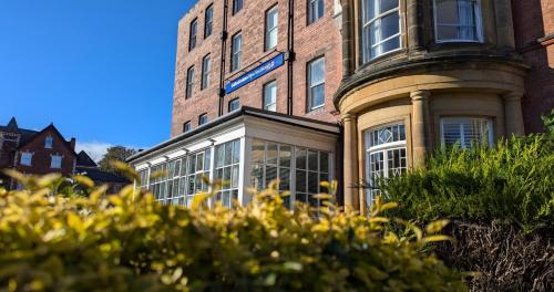 a large brick building with a large window at The Caledonian New Southlands Hotel in Scarborough