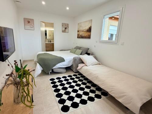 a bedroom with a bed and a couch in it at Cosy studio with garden in Chevry