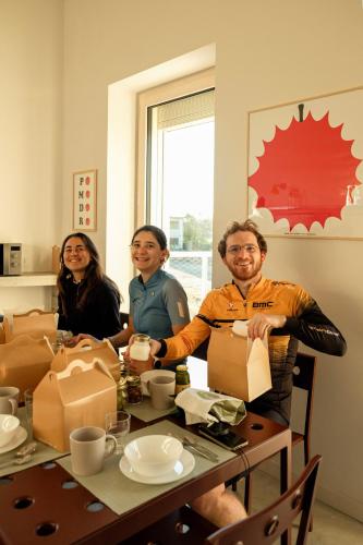 a group of three people sitting at a table with boxes at Gabanon in Casale Monferrato