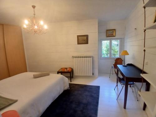 a bedroom with a bed and a desk and a piano at Maison de caractère Pezenas centre Garage XXL in Pézenas